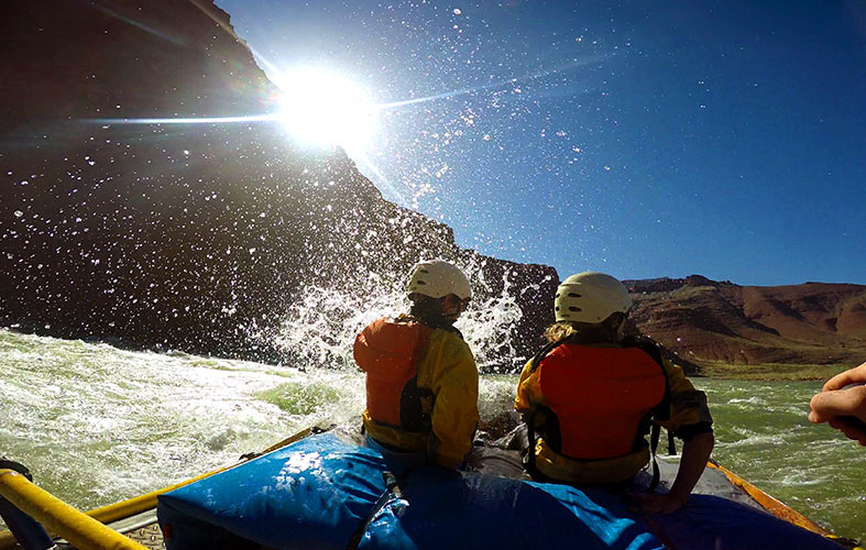 A view from inside a raft hitting rapids on the colorado river